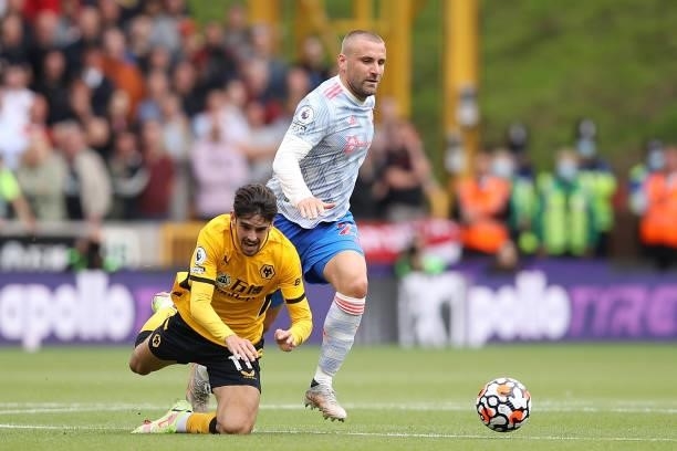 Francisco Trincao of Wolverhampton Wanderers is tackled by Luke Shaw of Manchester United during the Premier League match between Wolverhampton...