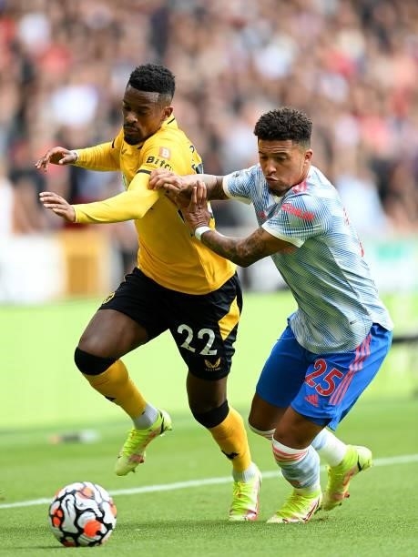 Nelson Semedo of Wolverhampton Wanderers battles for possession with Jadon Sancho of Manchester United during the Premier League match between...