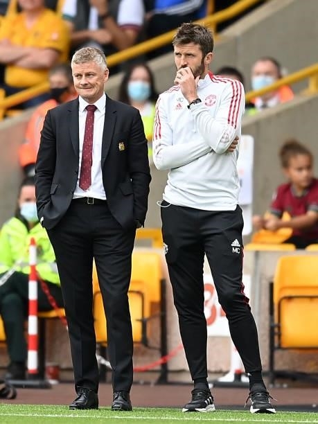Ole Gunnar Solskjaer, Manager of Manchester United looks on alongside Michael Carrick, First Team Coach of Manchester United during the Premier...