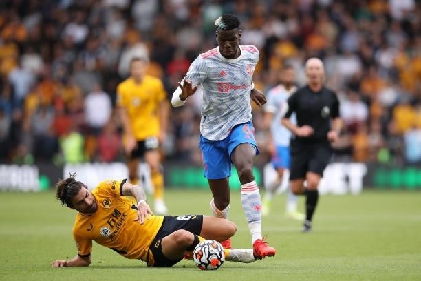Ruben Neves of Wolverhampton Wanderers battles for possession with Paul Pogba of Manchester United during the Premier League match between...