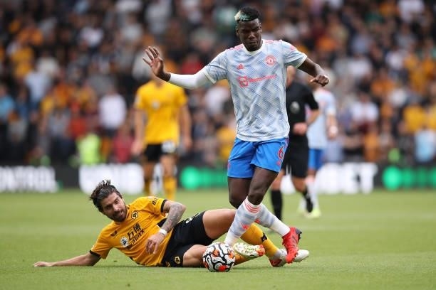 Ruben Neves of Wolverhampton Wanderers battles for possession with Paul Pogba of Manchester United during the Premier League match between...