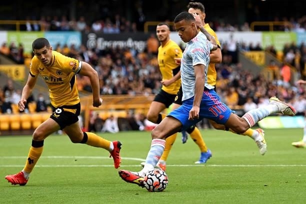 Mason Greenwood of Manchester United battles for possession with Conor Coady of Wolverhampton Wanderers during the Premier League match between...