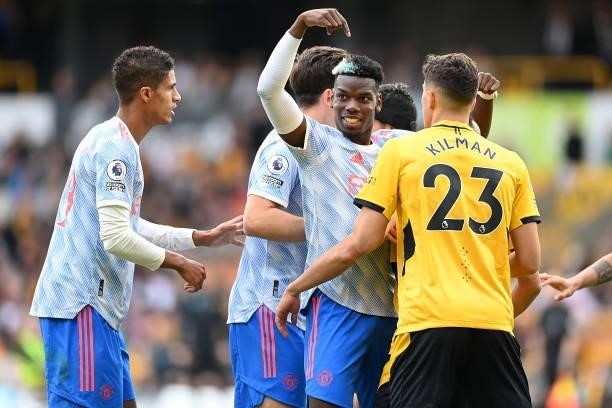 Paul Pogba of Manchester United interacts with Max Kilman of Wolverhampton Wanderers during the Premier League match between Wolverhampton Wanderers...