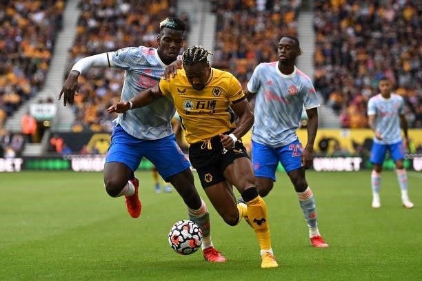 Adama Traore of Wolverhampton Wanderers battles for possession with Paul Pogba of Manchester United during the Premier League match between...
