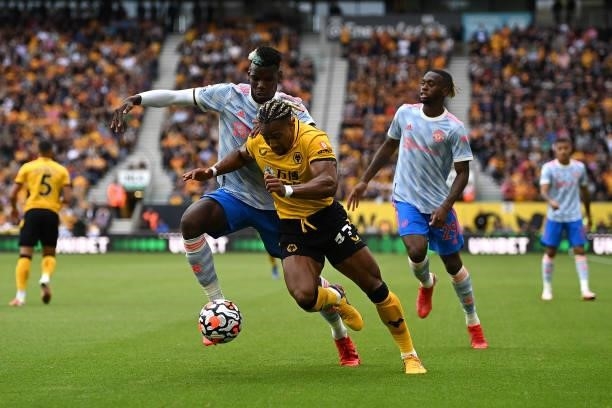 Adama Traore of Wolverhampton Wanderers battles for possession with Paul Pogba of Manchester United during the Premier League match between...