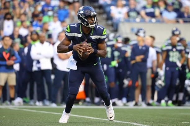 Geno Smith of the Seattle Seahawks looks to throw the ball against the Los Angeles Chargers in the first quarter during the NFL preseason game at...