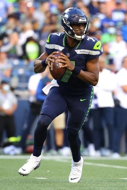 Geno Smith of the Seattle Seahawks looks to throw the ball against the Los Angeles Chargers in the first quarter during the NFL preseason game at...