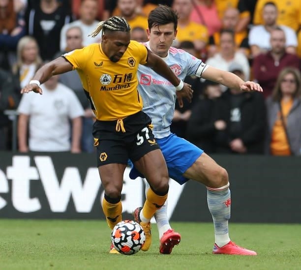 Harry Maguire of Manchester United in action with Adama Traore of Wolverhampton Wanderers during the Premier League match between Wolverhampton...