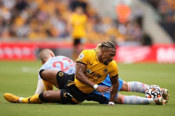 Adama Traore of Wolverhampton Wanderers is tackled by Luke Shaw of Manchester United during the Premier League match between Wolverhampton Wanderers...