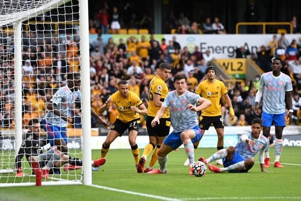 Harry Maguire of Manchester United clears the ball after a misssed chance by Romain Saiss of Wolverhampton Wanderers during the Premier League match...