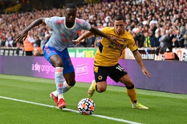 Aaron Wan-Bissaka of Manchester United battles for possession with Daniel Podence of Wolverhampton Wanderers during the Premier League match between...