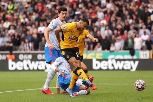 Romain Saiss of Wolverhampton Wanderers has a shot saved by David De Gea of Manchester United during the Premier League match between Wolverhampton...