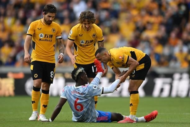 Paul Pogba of Manchester United interacts with Ruben Neves and Marcal of Wolverhampton Wanderers during the Premier League match between...