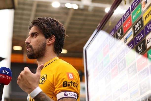 Ruben Neves of Wolverhampton Wanderers looks on as they are interviewed following the Premier League match between Wolverhampton Wanderers and...