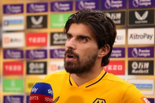 Ruben Neves of Wolverhampton Wanderers looks on as they are interviewed following the Premier League match between Wolverhampton Wanderers and...