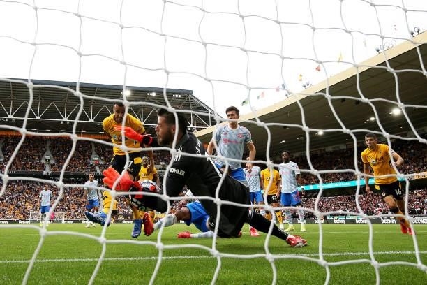 Romain Saiss of Wolverhampton Wanderers has his shot saved by David de Gea of Manchester United during the Premier League match between Wolverhampton...