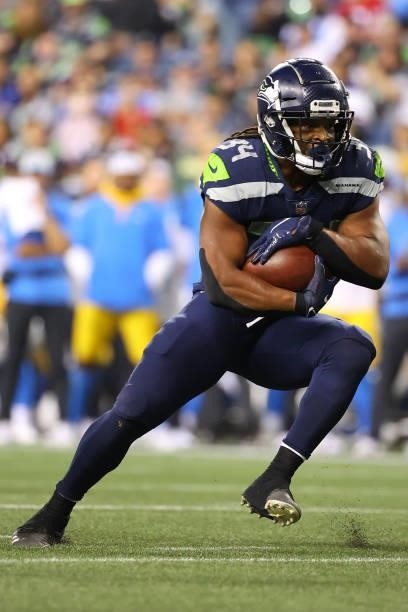 Josh Johnson of the Seattle Seahawks carries the ball against the Los Angeles Chargers in the fourth quarter during the NFL preseason game at Lumen...