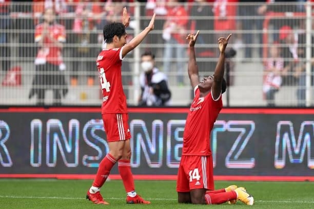 Taiwo Awoniyi of 1.FC Union Berlin celebrates with Genki Haraguchi of 1.FC Union Berlin after scoring their sides second goal during the Bundesliga...