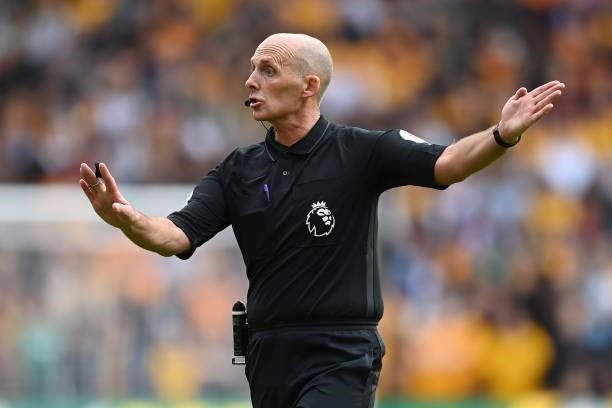 Referee Mike Dean gestures during the Premier League match between Wolverhampton Wanderers and Manchester United at Molineux on August 29, 2021 in...