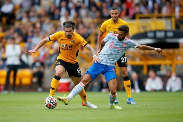 Ruben Neves of Wolverhampton Wanderers competes for the ball with Bruno Fernandes of Manchester United during the Premier League match between...