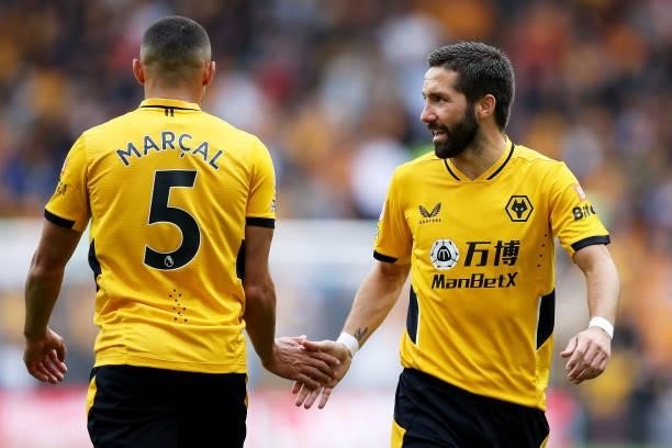 Joao Moutinho of Wolverhampton Wanderers high fives Marcal during the Premier League match between Wolverhampton Wanderers and Manchester United at...