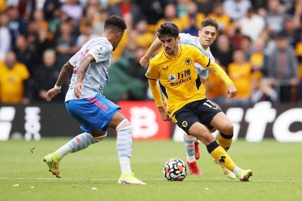 Francisco Trincao of Wolverhampton Wanderers runs with the ball under pressure from Jadon Sancho of Manchester United during the Premier League match...