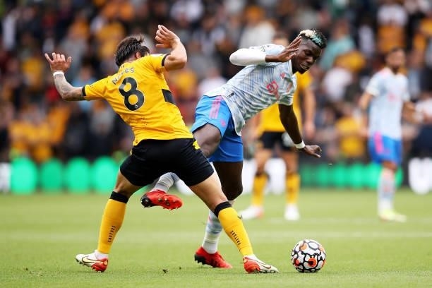 Paul Pogba of Manchester United is challenged by Ruben Neves of Wolverhampton Wanderers during the Premier League match between Wolverhampton...
