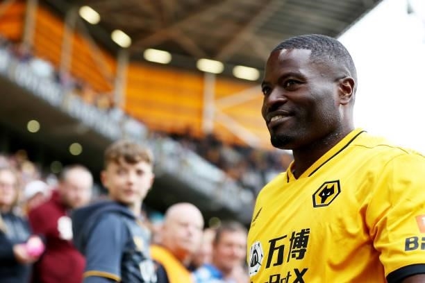 Former Wolverhampton Wanderers player, George Elokobi shows appreciation to the fans at half-time during the Premier League match between...