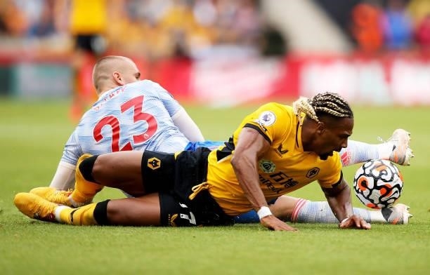 Adama Traore of Wolverhampton Wanderers battles for possession against Luke Shaw of Manchester United during the Premier League match between...