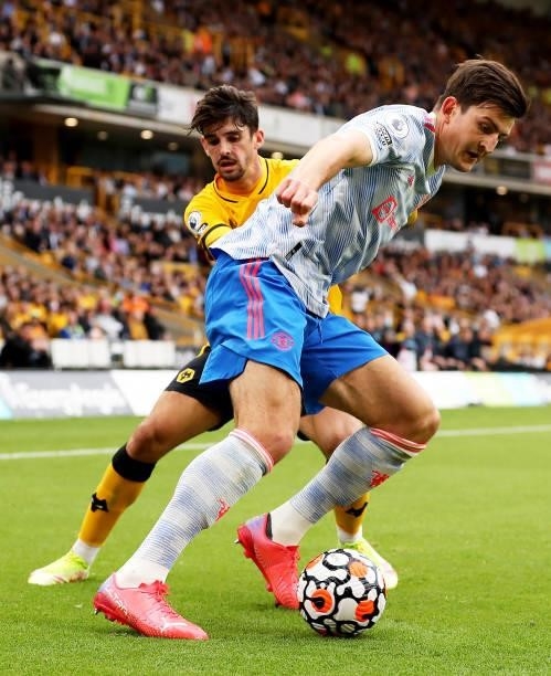 Harry Maguire of Manchester United is challenged by Francisco Trincao of Wolverhampton Wanderers during the Premier League match between...