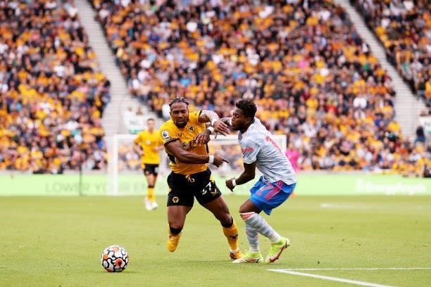Adama Traore of Wolverhampton Wanderers runs with the ball under pressure from Fred of Manchester United during the Premier League match between...
