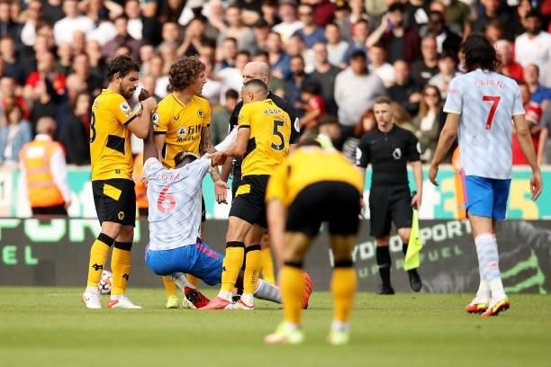 Ruben Neves, Fabio Silva and Marcal of Wolverhampton Wanderers attempt to pull up Paul Pogba of Manchester United during the Premier League match...