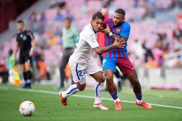 Memphis Depay of FC Barcelona fights for the ball with Damian Suarez of Getafe CF during the La Liga Santander match between FC Barcelona and Getafe...