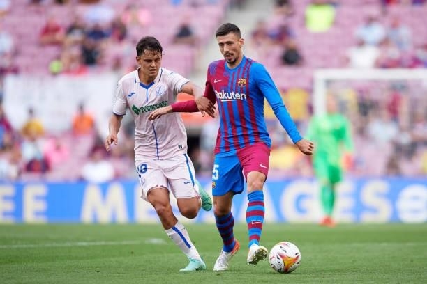 Clement Lenglet of FC Barcelona plays the ball under pressure from Enes Unal of Getafe CF during the La Liga Santander match between FC Barcelona and...