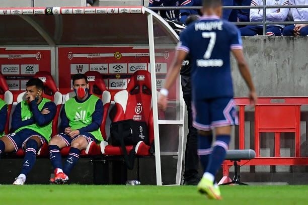 Lionel Messi of Paris Saint-Germain looks on as he sits on the bench during the Ligue 1 Uber Eats match between Reims and Paris Saint Germain at...
