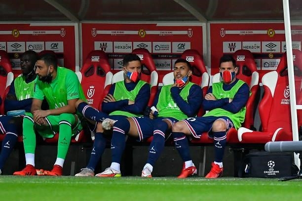 Gianluigi Donnarumma, Ander Herrera, Leandro Paredes and Lionel Messi of Paris Saint-Germain look on as they sit on the bench during the Ligue 1 Uber...