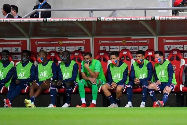 Lionel Messi, Leandro Parades, Ander Herrera and Guianluigi Donnarumma sit on the bench during the Ligue 1 Uber Eats match between Reims and Paris...
