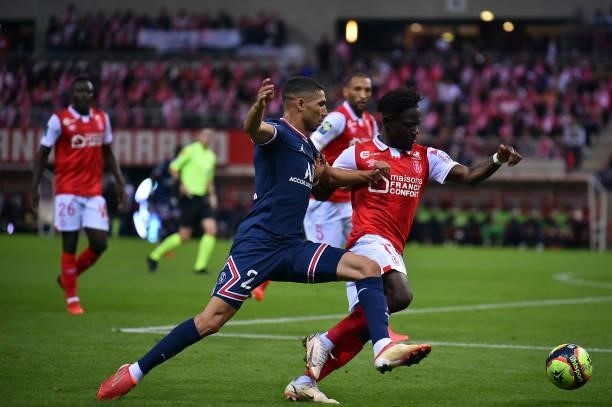 Achraf Hakimi of Paris Saint-Germain fights for possession during the Ligue 1 Uber Eats match between Reims and Paris Saint Germain at Stade Auguste...