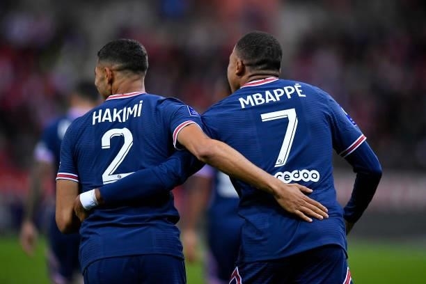 Kylian Mbappe of Paris Saint-Germain is congratulated by Achraf Hakimi after scoring during the Ligue 1 Uber Eats match between Reims and Paris Saint...
