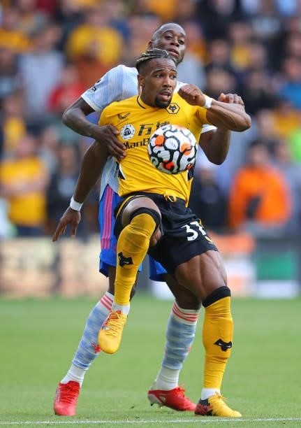 Adama Traore of Wolverhampton Wanderers holds off a challenge from Aaron Wan-Bissaka of Manchester United during the Premier League match between...