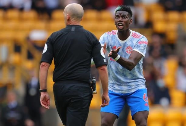 Paul Pogba of Manchester United reacts towards referee Mike Dean during the Premier League match between Wolverhampton Wanderers and Manchester...
