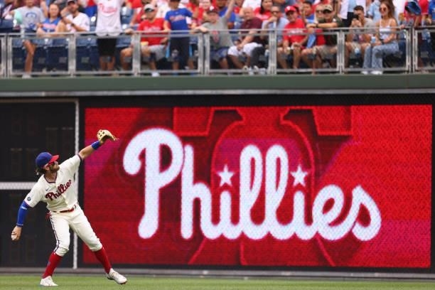 Bryce Harper of the Philadelphia Phillies throws a ball into the stands before a game against the Arizona Diamondbacks at Citizens Bank Park on...