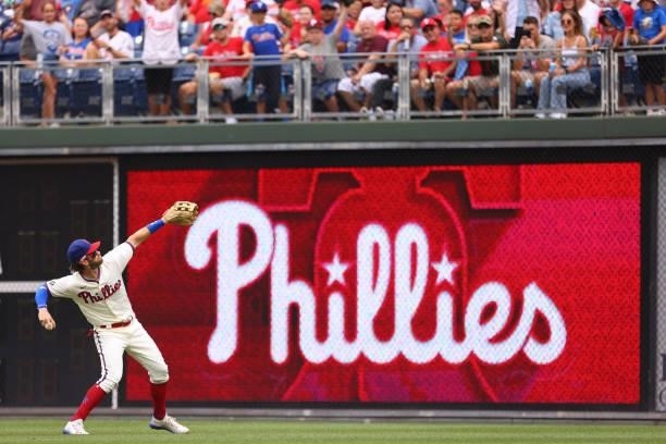 Bryce Harper of the Philadelphia Phillies throws a ball into the stands before a game against the Arizona Diamondbacks at Citizens Bank Park on...
