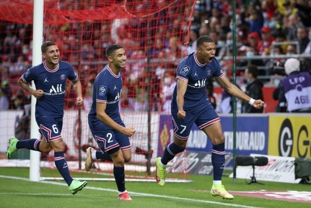 Kylian Mbappe of PSG celebrates his first goal with Achraf Hakimi, Marco Verratti during the Ligue 1 Uber Eats match between Stade Reims and Paris...