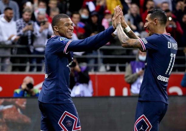 Kylian Mbappe of PSG celebrates his second goal with Angel Di Maria during the Ligue 1 Uber Eats match between Stade Reims and Paris Saint Germain at...