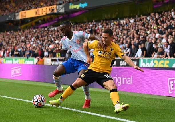 Aaron Wan-Bissaka of Manchester United battles for possession with Daniel Podence of Wolverhampton Wanderers during the Premier League match between...