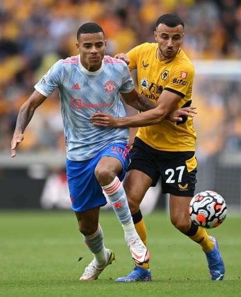 Mason Greenwood of Manchester United battles for possession with Romain Saiss of Wolverhampton Wanderers during the Premier League match between...