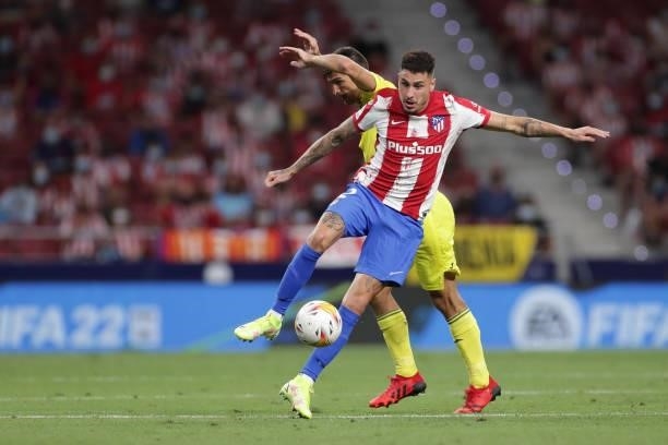 Jose Maria Gimenez of Atletico de Madrid competes for the ball with Gerard Moreno of Villarreal CF during the La Liga Santader match between Club...
