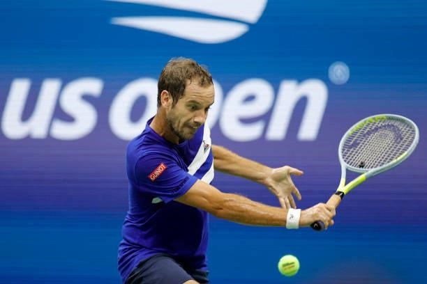 Richard Gasquet of France returns the ball against Daniil Medvedev of Russia during their Men's Singles first round match on Day One of the 2021 US...