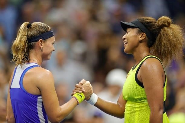 Naomi Osaka of Japan shakes hands with Marie Bouzkova of the Czech Republic after winning during their Women's Singles first round match on Day One...